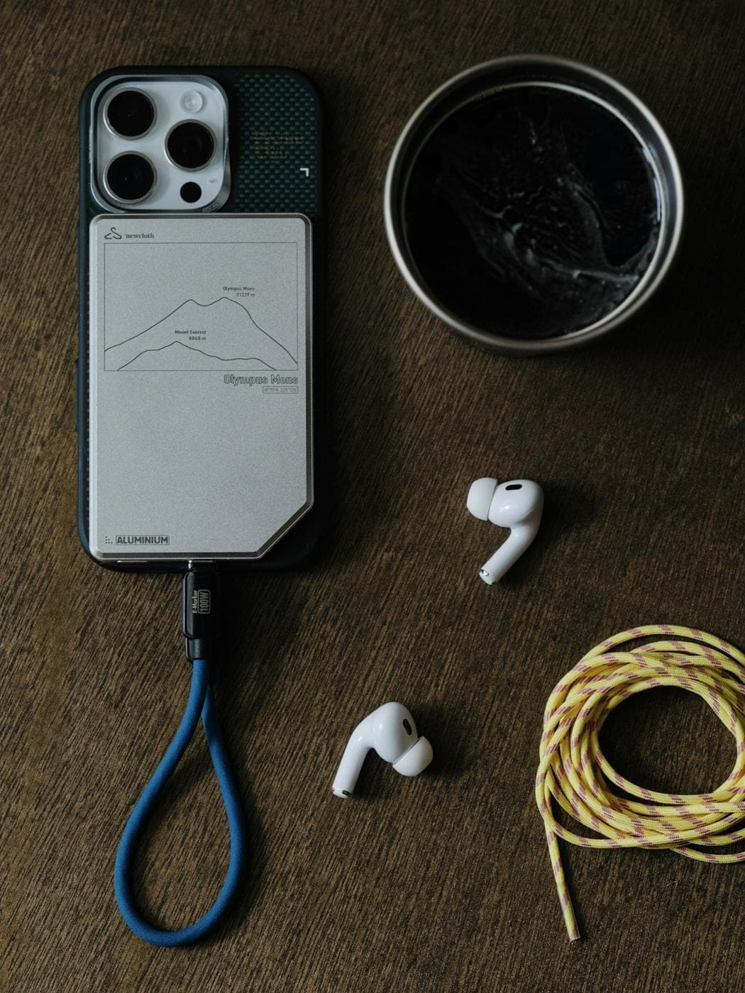 Téléphone avec un cordon tour de cou, à côté d’écouteurs